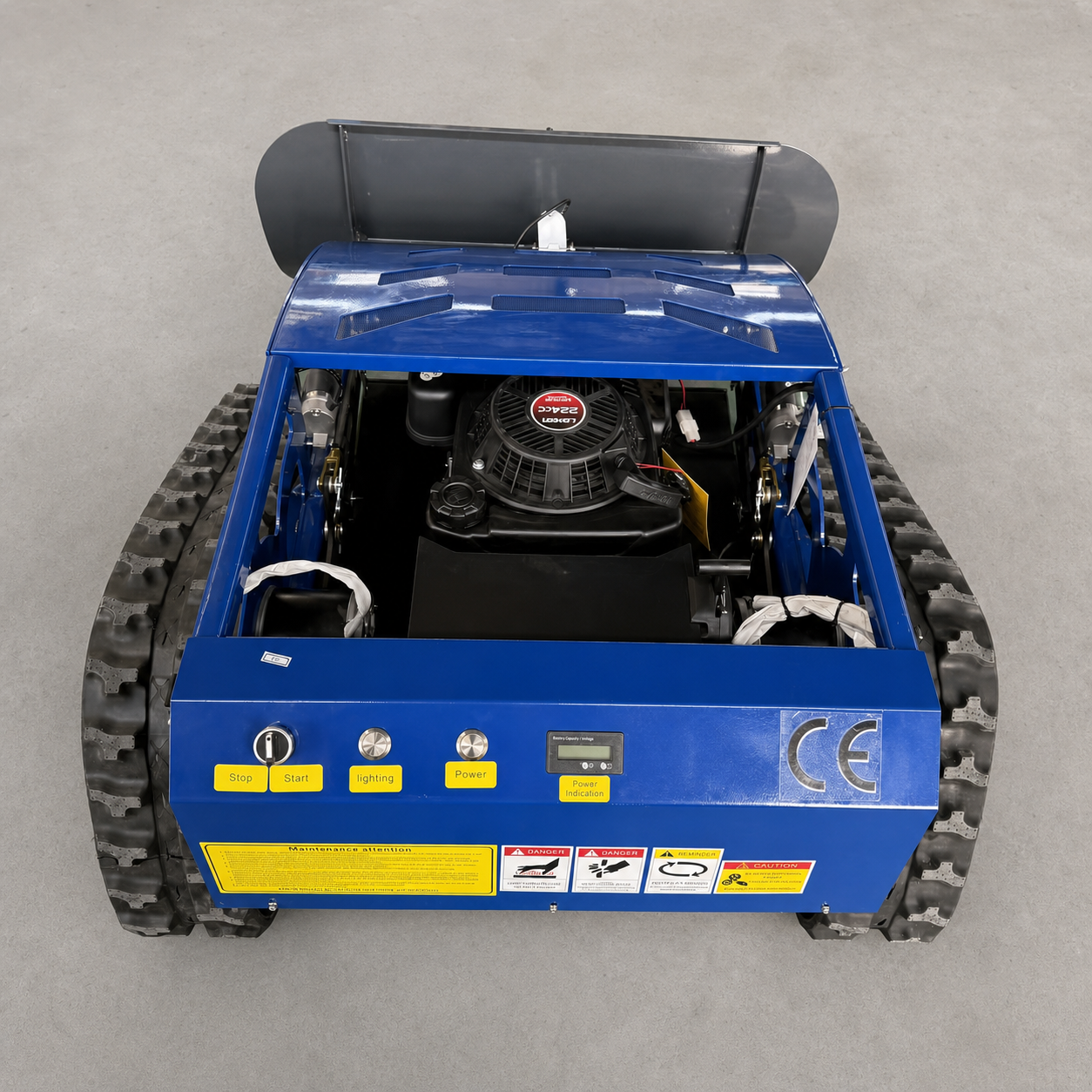 Tracked mower with snow shovel accessory